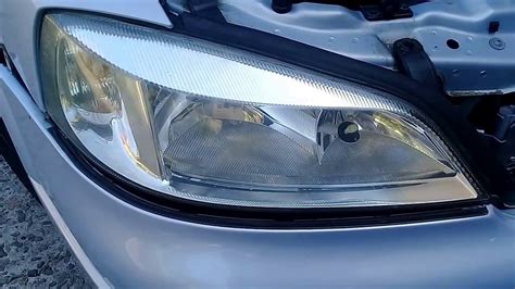 Установка автодетали для чистки передних фар на автомобиле Тойота Кэмри нового поколения